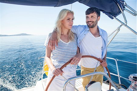 simsearch:6115-08239578,k - Young couple steering together on sailboat, Adriatic Sea Stock Photo - Premium Royalty-Free, Code: 6115-08239705