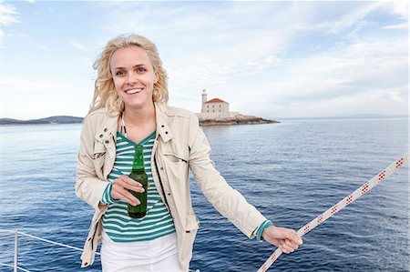 simsearch:6115-08101096,k - Young woman drinking beer on sailboat, Adriatic Sea Stock Photo - Premium Royalty-Free, Code: 6115-08239814