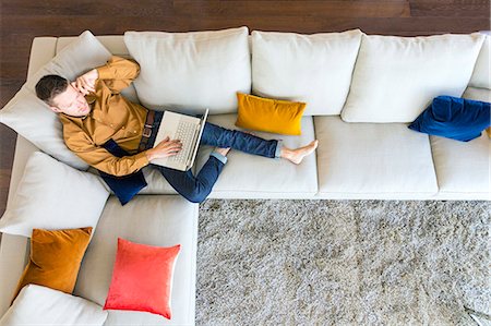 Couple relaxing in modern apartment Stock Photo - Premium Royalty-Free, Code: 6115-08416176