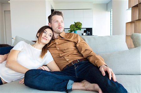 Couple relaxing in modern apartment Stock Photo - Premium Royalty-Free, Code: 6115-08416178