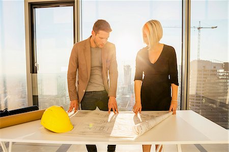 simsearch:6115-08416163,k - Architects in office examining blueprint Stock Photo - Premium Royalty-Free, Code: 6115-08416185