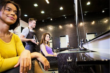 Customer with hairstylists in hair salon Stock Photo - Premium Royalty-Free, Code: 6115-08416289