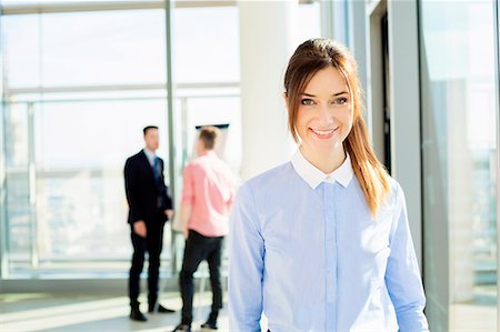 simsearch:6115-08416260,k - Well-dressed businesswoman with colleagues in background Photographie de stock - Premium Libres de Droits, Code: 6115-08416297