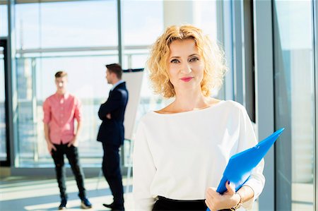 simsearch:6115-08416163,k - Well-dressed businesswoman with colleagues in background Stock Photo - Premium Royalty-Free, Code: 6115-08416298