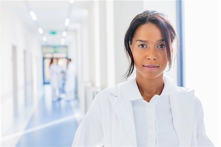 Portrait of female doctor in hospital corridor Stock Photo - Premium Royalty-Free, Code: 6115-08416210