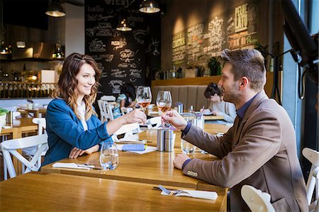 simsearch:6115-08416163,k - Couple toasting with wine in a restaurant Stock Photo - Premium Royalty-Free, Code: 6115-08416231