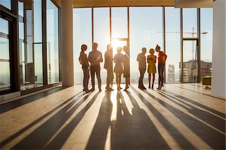 silhouette of businessman standing in office - Team of architects in business meeting against urban skyline Stock Photo - Premium Royalty-Free, Code: 6115-08416345