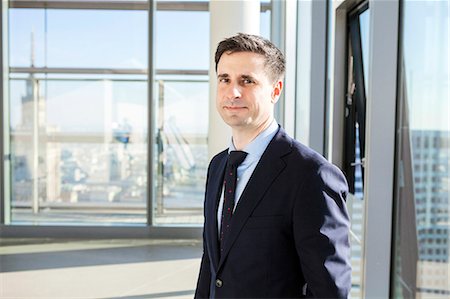 Portrait of well-dressed businessmen in modern office Stock Photo - Premium Royalty-Free, Code: 6115-08416322