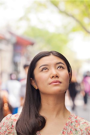 simsearch:6116-07235632,k - Young Woman looking up Stock Photo - Premium Royalty-Free, Code: 6116-06938574