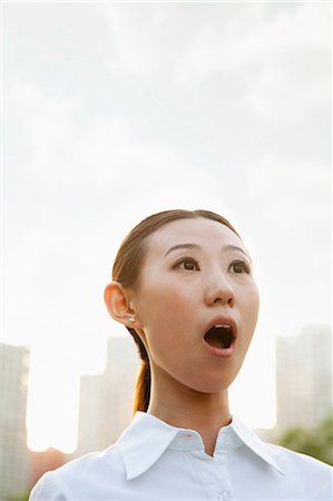 shocking - Portrait of shocked young woman outside, Beijing Stock Photo - Premium Royalty-Free, Code: 6116-06938591