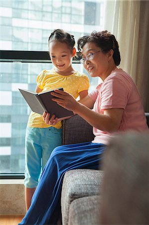 simsearch:6116-06938999,k - Grandmother reading book to her granddaughter Stock Photo - Premium Royalty-Free, Code: 6116-06938675