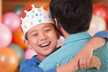 festive - Birthday Boy Hugging His Father Stock Photo - Premium Royalty-Free, Code: 6116-06938729
