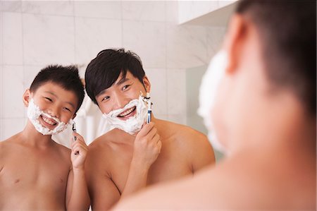 Father and Son Shaving Together Stock Photo - Premium Royalty-Free, Code: 6116-06938734