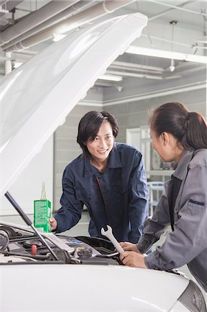 simsearch:6116-07085696,k - Mechanics Working on Car in Auto Repair Shop Stock Photo - Premium Royalty-Free, Code: 6116-06938834