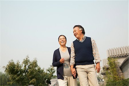 Senior couple going for a stroll in Beijing, holding hands Stock Photo - Premium Royalty-Free, Code: 6116-06938993