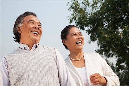 senior man looking up smiling - Happy senior couple walking outdoors in Beijing Stock Photo - Premium Royalty-Free, Code: 6116-06938992