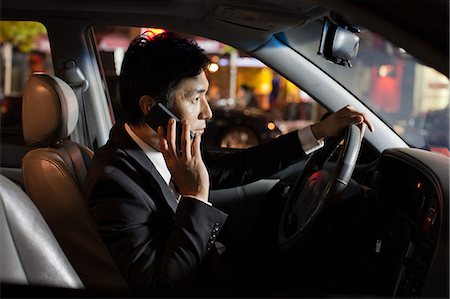person looking at phone and car - Businessman With Cell Phone In Car Stock Photo - Premium Royalty-Free, Code: 6116-06938913
