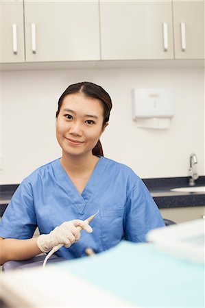 female dentist looking at camera - Portrait Of Female Dental Assistant Stock Photo - Premium Royalty-Free, Code: 6116-06938933