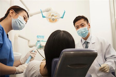 Dentists Examining Female Patient Stock Photo - Premium Royalty-Free, Code: 6116-06938938