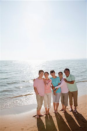 family of five hugging - Multi generational family portrait, arms around each other by the beach Stock Photo - Premium Royalty-Free, Code: 6116-06939014