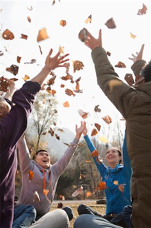 simsearch:6116-06939163,k - Group of young people throwing leaves Stock Photo - Premium Royalty-Free, Code: 6116-06939162