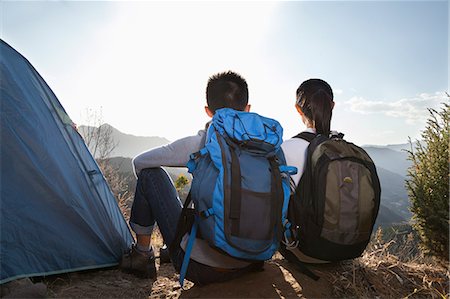 simsearch:6116-06939320,k - Young couple sitting next to the tent Foto de stock - Sin royalties Premium, Código: 6116-06939185