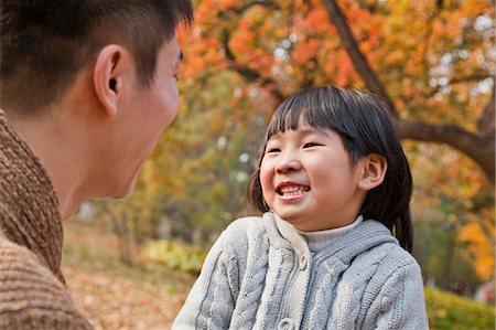 ethnic - Father and daughter looking at each other in the park, autumn Stock Photo - Premium Royalty-Free, Code: 6116-06939262