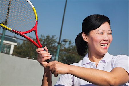 Mature woman playing tennis, portrait Stock Photo - Premium Royalty-Free, Code: 6116-06939295
