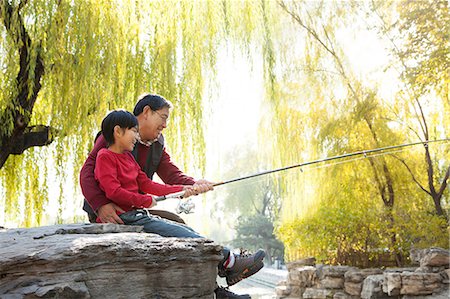 senior education - Grandfather and grandson fishing portrait at lake Stock Photo - Premium Royalty-Free, Code: 6116-06939374