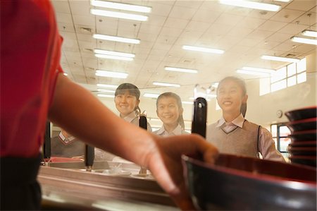 simsearch:6116-06939482,k - School cafeteria worker serves noodles to students Stock Photo - Premium Royalty-Free, Code: 6116-06939450