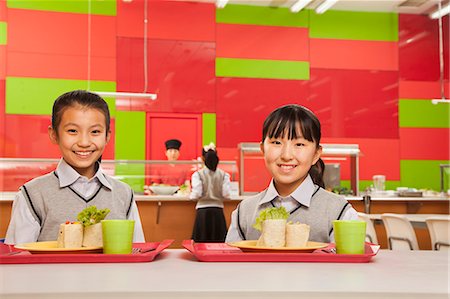 simsearch:6116-06939237,k - Two girls sitting in school cafeteria Stock Photo - Premium Royalty-Free, Code: 6116-06939455