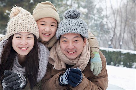 father son asian - Family laying in snow for portrait Stock Photo - Premium Royalty-Free, Code: 6116-06939549