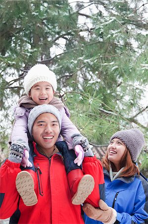 simsearch:6116-07086137,k - Father carrying daughter on shoulders in winter Stock Photo - Premium Royalty-Free, Code: 6116-06939565