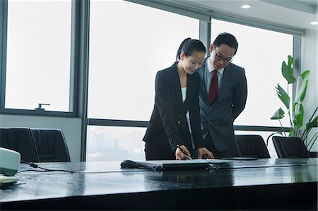 east asian meeting office - Businesspeople Working Together Stock Photo - Premium Royalty-Free, Code: 6116-06939584