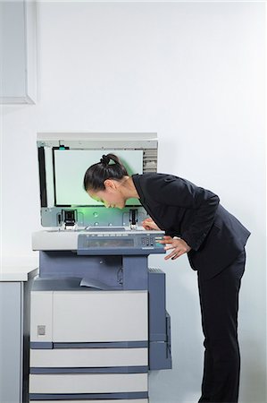 simsearch:6116-06939598,k - Businesswoman Photocopying Her Face Stock Photo - Premium Royalty-Free, Code: 6116-06939599