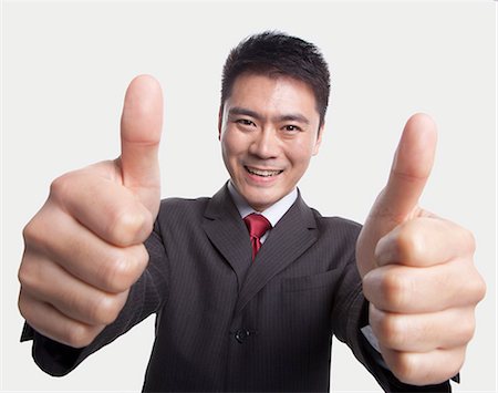 Businessman Giving Thumbs-Up Photographie de stock - Premium Libres de Droits, Code: 6116-07084643