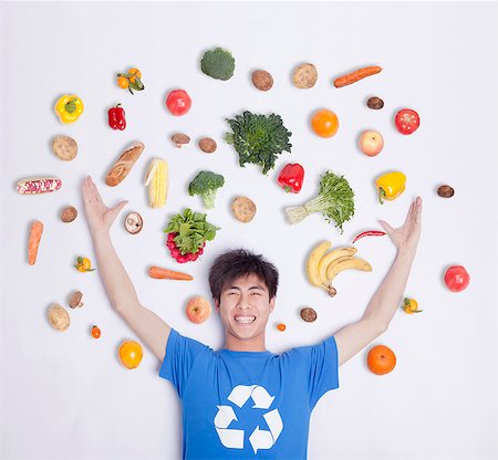 simsearch:6116-07084668,k - Young man with fresh fruit and vegetables, studio shot Stock Photo - Premium Royalty-Free, Code: 6116-07084659