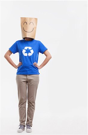 simsearch:6116-07084668,k - Young woman with smiley face paper bag over her head Stock Photo - Premium Royalty-Free, Code: 6116-07084681