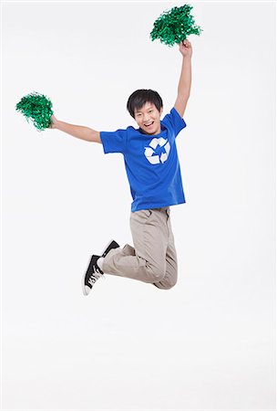 simsearch:6116-07084668,k - Young man with recycling t-shirt cheering with pompoms, studio shot Stock Photo - Premium Royalty-Free, Code: 6116-07084692