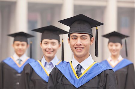 simsearch:6116-06939213,k - Four University Graduates Smiling, Looking at Camera Photographie de stock - Premium Libres de Droits, Code: 6116-07084623