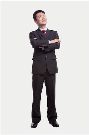 suit man asian - Businessman Looking Up, Full Length Photographie de stock - Premium Libres de Droits, Code: 6116-07084635