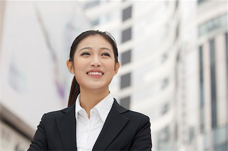 simsearch:649-08145347,k - Portrait of smiling young businesswoman, outdoors, Beijing, China Stock Photo - Premium Royalty-Free, Code: 6116-07084764