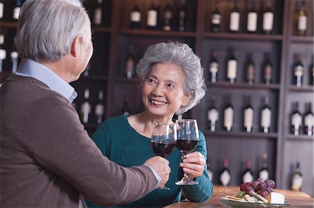 simsearch:6116-07235672,k - Senior Couple Toasting and Enjoying Themselves Drinking Wine, Focus on Female Stock Photo - Premium Royalty-Free, Code: 6116-07084739