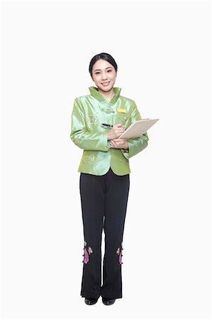 smile and greeting - Restaurant/Hotel Hostess in traditional Chinese clothing holding clipboard Stock Photo - Premium Royalty-Free, Code: 6116-07084890