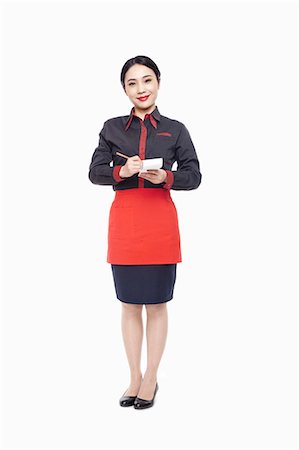 Young Waitress writing order on note pad, smiling, studio shot Stock Photo - Premium Royalty-Free, Code: 6116-07084898