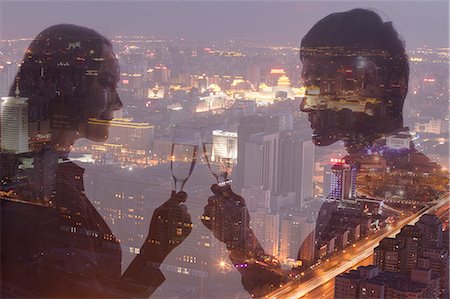 peking night people - Double exposure of couple toasting with champagne flutes over night cityscape Stock Photo - Premium Royalty-Free, Code: 6116-07084826