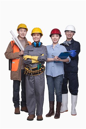 Group of construction workers standing against white background, smiling, portrait Stock Photo - Premium Royalty-Free, Code: 6116-07084941