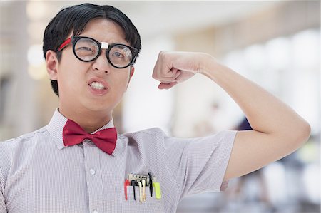 funny photos of biceps - Nerdy Man Flexing His Bicep Stock Photo - Premium Royalty-Free, Code: 6116-07084967