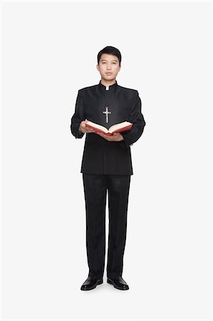 simsearch:6116-07085230,k - Young Priest Standing with Bible Stock Photo - Premium Royalty-Free, Code: 6116-07084984