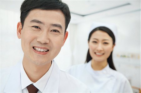 simsearch:6116-07084889,k - Portrait of Doctor, Nurse in Background Stock Photo - Premium Royalty-Free, Code: 6116-07084918